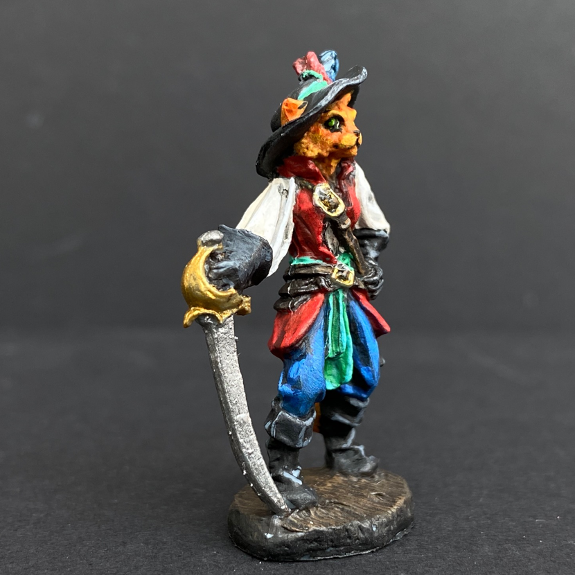 Hand painted debonair cat from the Reaper Miniatures range. Mrs MLG has painted this catfolk cavalier as a ginger cat with a blue, green and red colour scheme clothing having black hat, boots and gloves. 