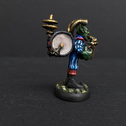 Hand painted one man band from the Reaper Miniatures range. Mrs MLG has painted this wonderful little goblin playing all his instruments for the one man band using a blue and red colour scheme for his clothing. 