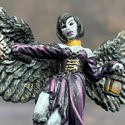 Angel of Shadows from the reaper miniatures bones range pre painted by Mrs MLG. This angelic miniature is painted with purples, blues, grey and golds, she holds a sword in one hand and a lantern in the other.