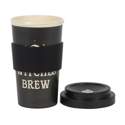 travel mug in a stippled black colour with a crescent moon and star design and the words 'Witches Brew', black sleeve and a black lid on the floor at the side