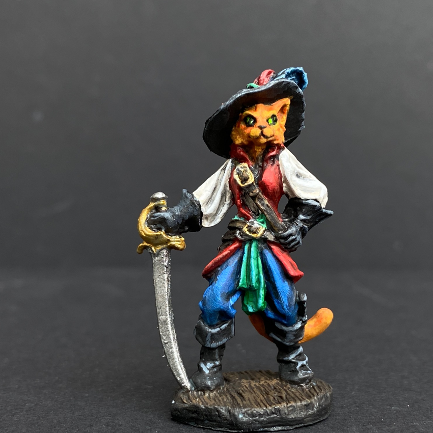 Hand painted debonair cat from the Reaper Miniatures range. Mrs MLG has painted this catfolk cavalier as a ginger cat with a blue, green and red colour scheme clothing having black hat, boots and gloves. 