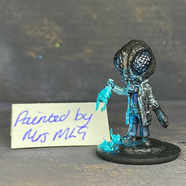 A Reaper Miniatures bonesylvanian Jaques hand painted by Mrs MLG. This scientist may have taken his experiments too far as he now has the head and one hand of a bug. Mrs MLG has painted this little fella with his glass flask broken and the contents spilling out onto the floor. 