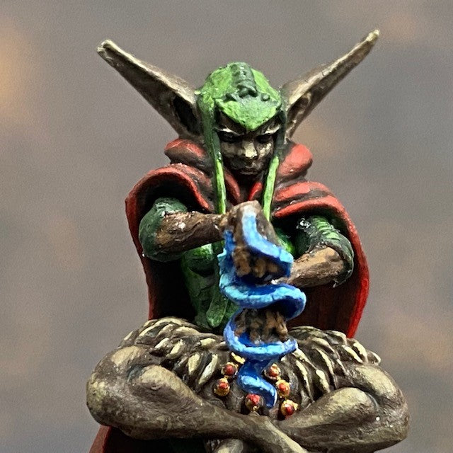 Raegan Priestess from the Monnstone malachite mystics troupe box pre painted by Mrs MLG. This Leshavult priestess miniature is painted with reds, browns, blue and greens.