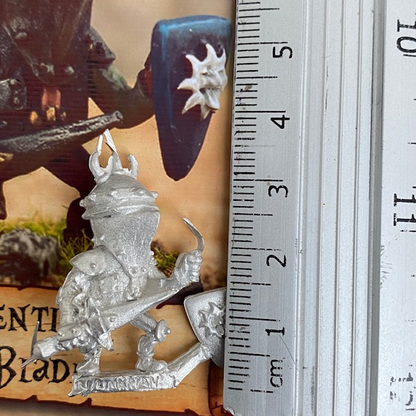 Sentinel Blade by Northumbrian Tin Solider from the Nightfolk sentinel range wears battered armour with a horned helmet, carries a shield with a sun sticking its tongue out on the front